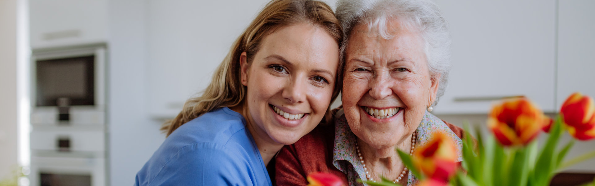 Caregiver hugging elderly