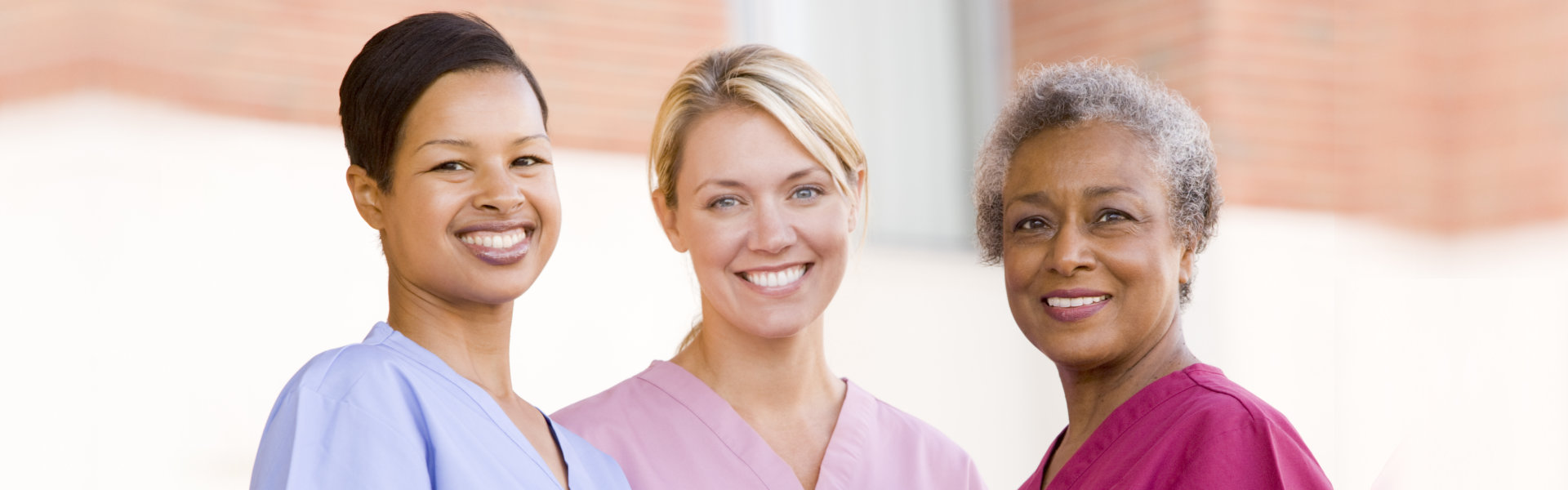Three smiling female caregivers